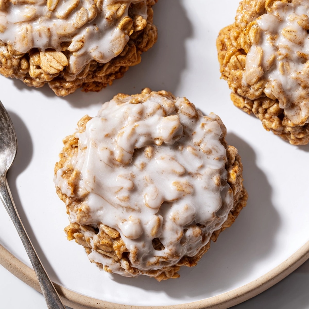 Golden brown Iced Oatmeal Cookies, drizzled with sweet glaze and ready to enjoy.