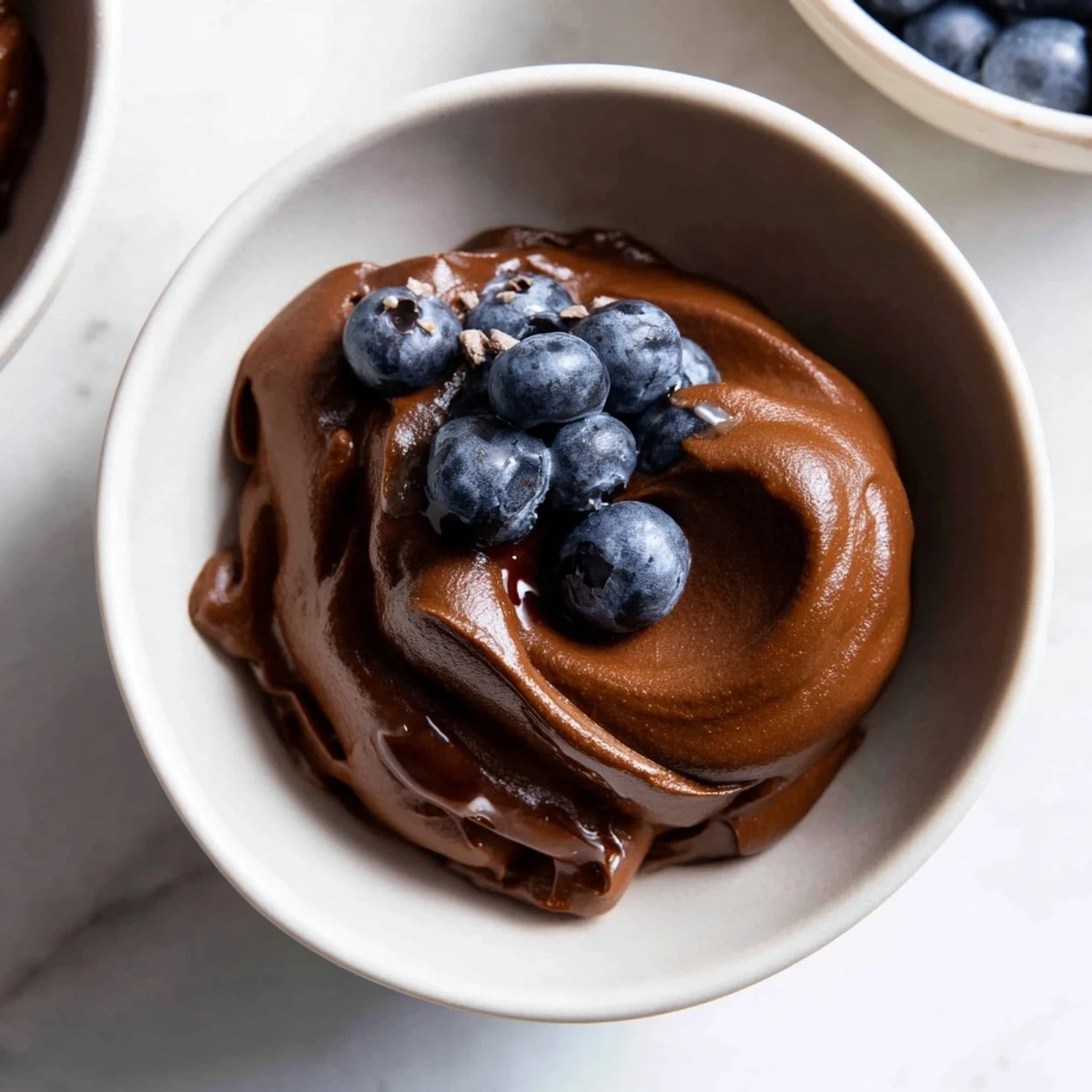 Smooth, dark chocolate avocado mousse, creamy vegan dessert, ready to chill and enjoy.