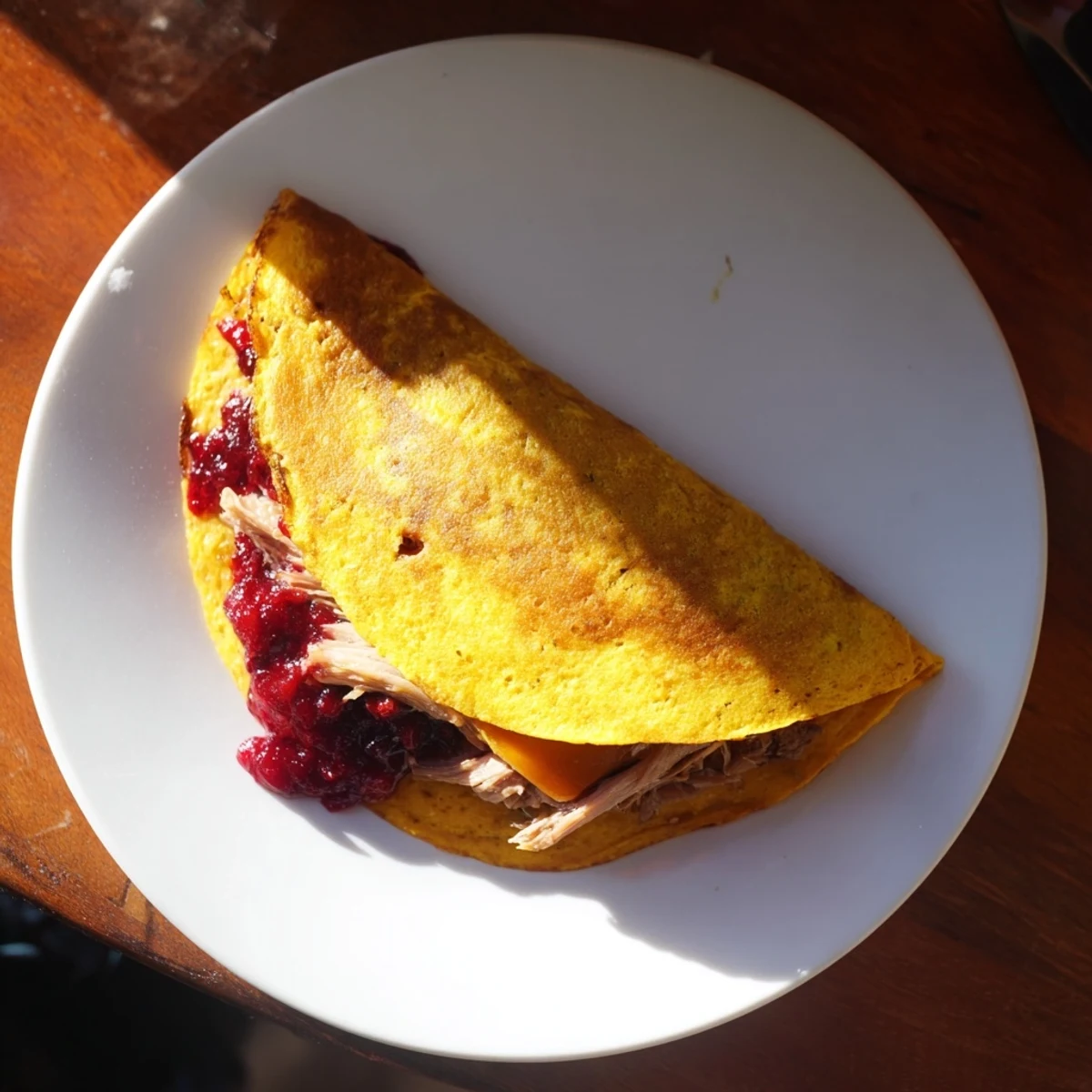 Melted cheese oozes from a delicious Turkey, Stuffing and Cranberry Leftovers Tortilla Wrap, a holiday leftover hack.