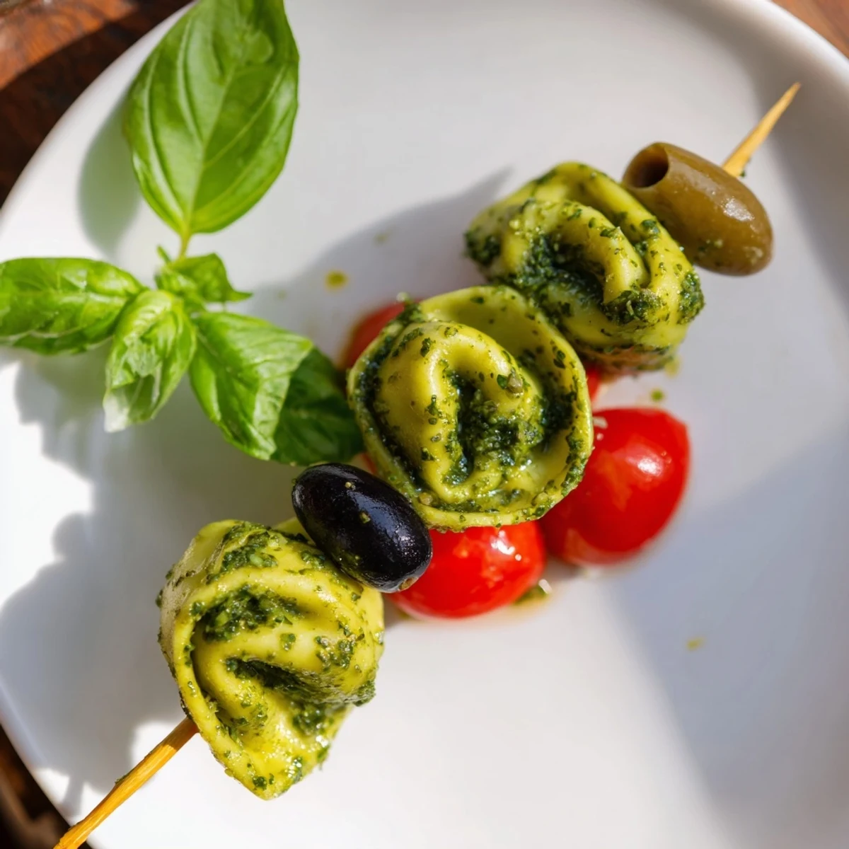 Appetizer Skewers display a colorful array of tortellini, olives, and pesto, perfect for easy grabbing.