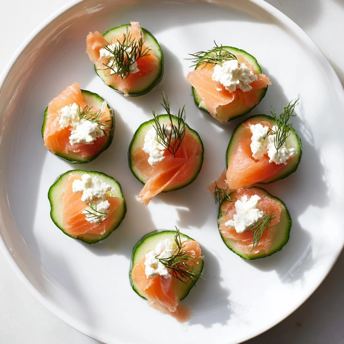 Elegant arrangement of Champagne pairings includes smoked salmon, goat cheese bites, and fresh fruit for an event.