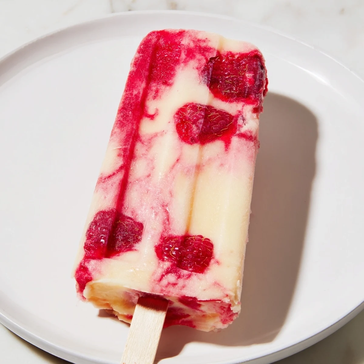 Enjoy a refreshing Raspberry Coconut Ice Pop, a sweet and icy treat ready to serve after freezing.
