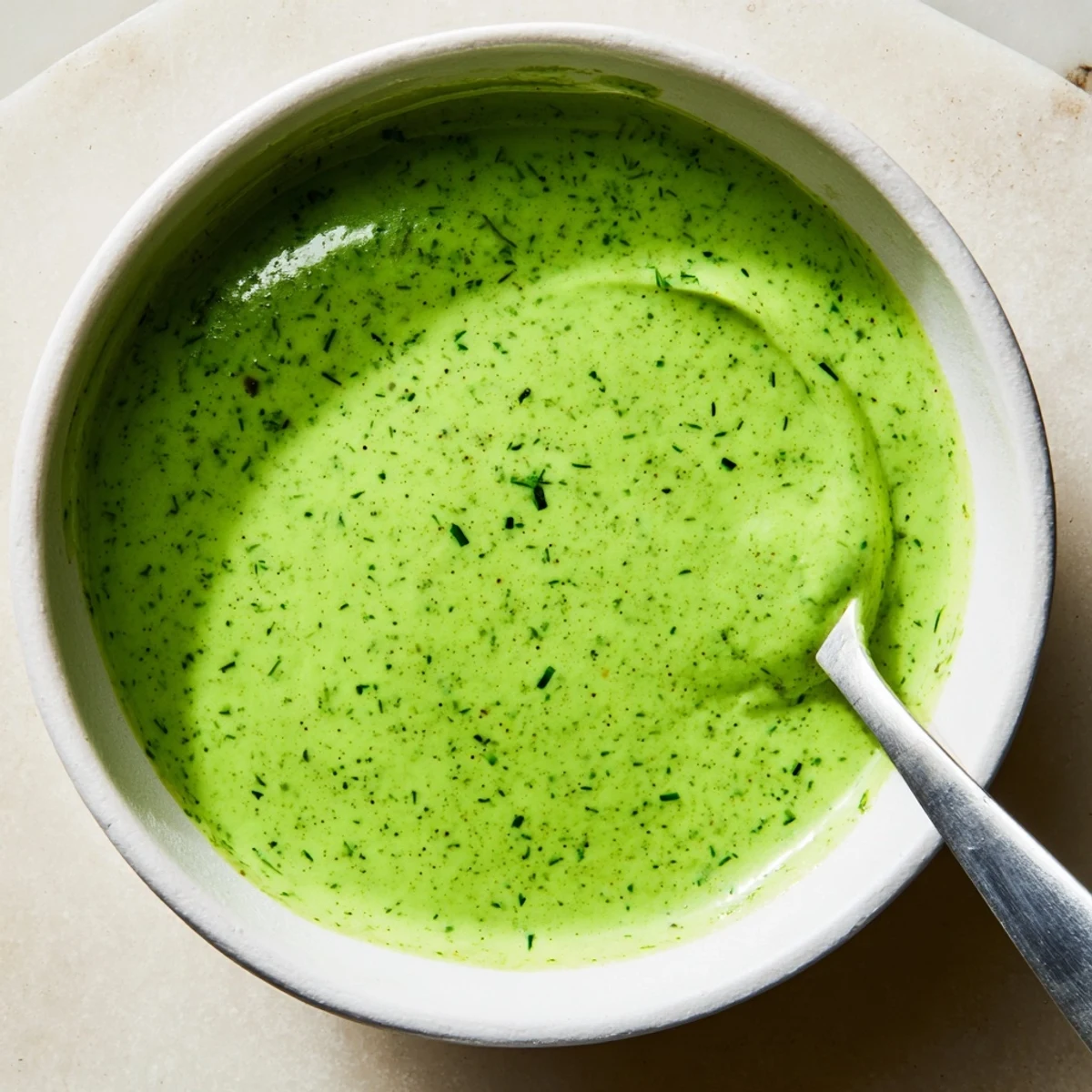 Homemade Green Goddess Dressing served as a dip with crunchy vegetable crudités for a healthy snack.