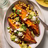 Steaming Loaded Baked Sweet Potatoes, loaded with black beans, cheese, and fresh cilantro, are delicious.