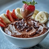 Creamy cottage cheese brownie batter dip served with colorful fruit dippers for a healthy, protein-packed dessert.