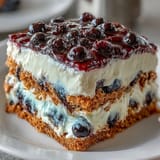 Lemon Blueberry Icebox Cake: Tangy lemon cream, juicy berries, and soft graham crackers.