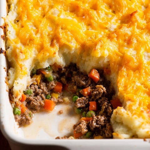Ultimate Cheesy Shepherd's Pie with a bubbly, golden cheese crust and savory ground beef filling.
