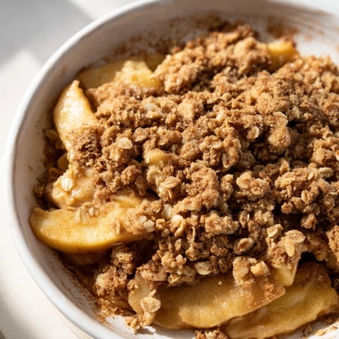 Warm Cinnamon Oat Apple Crisp bubbling hot, with golden oat crisp topping after baking.