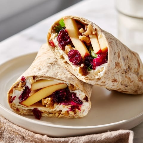 Savory Cranberry Goat Cheese & Walnut Wrap, tightly rolled with visible filling, ready to serve.