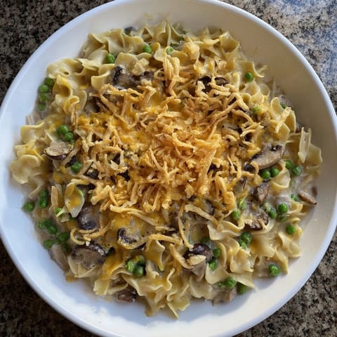 Creamy, bubbly Tuna Noodle Casserole, baked and topped with crunchy fried onions, ready for dinner.