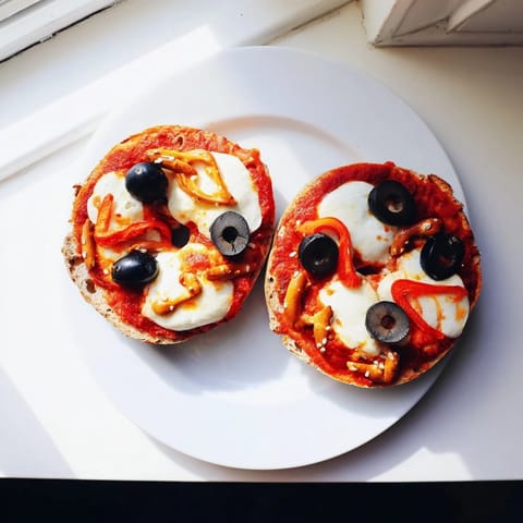 Deliciously melted mozzarella tops these reindeer face pizza bagels, complete with pretzel antlers and olive eyes.