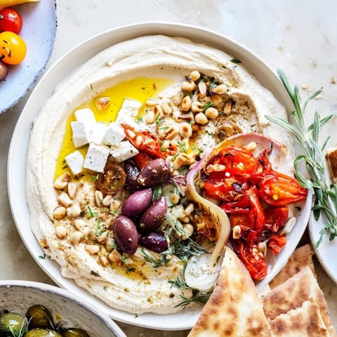 Vibrant Mediterranean mezza platter featuring feta cubes, olives, and a drizzle of olive oil.