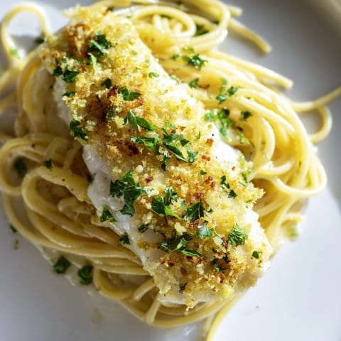 Zesty Lemon Bass Pasta tossed in a buttery garlic sauce with flaky white fish.