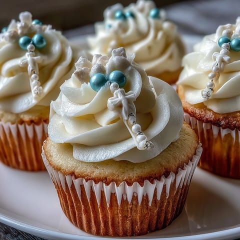 Mini First Communion Cupcakes with Rosary Fondant Toppers: Soft vanilla cupcakes topped with smooth buttercream and delicate fondant rosary toppers for a meaningful celebration.