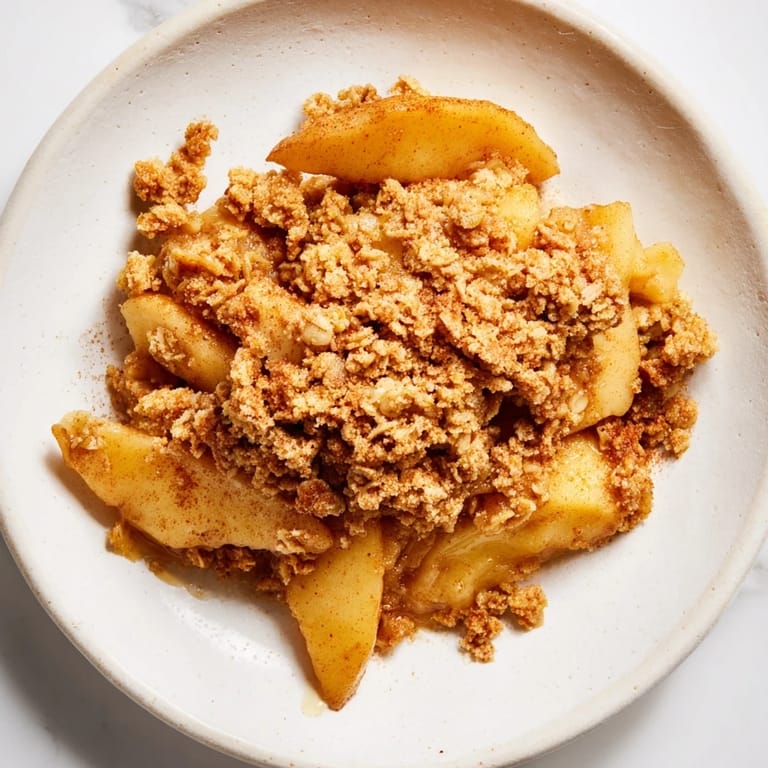 Freshly baked Warm Cinnamon Oat Apple Crisp, a delicious dessert with tender apples and sweet spiced oats.