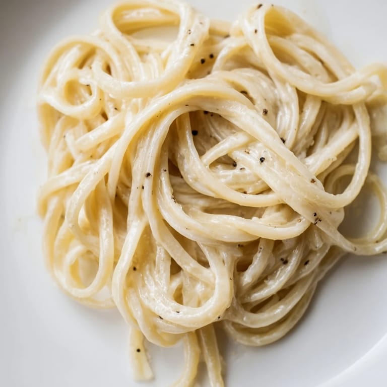 Close-up shot shows the perfectly glossy, easy Lazy Girl Three-Ingredient Pasta, ideal for a quick dinner.