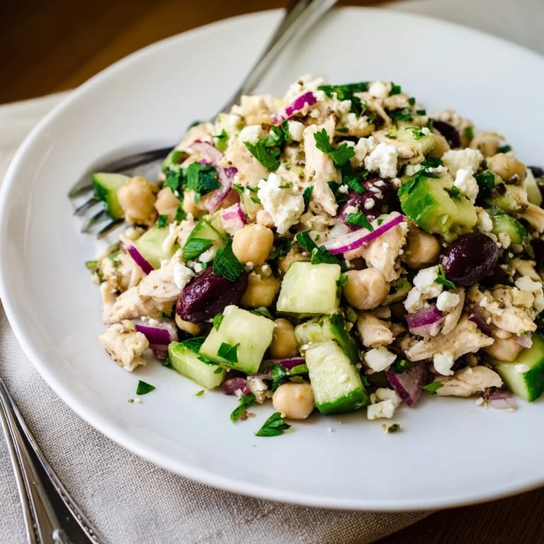 Tossing Mediterranean Chickpea Chicken Salad with golden chicken, chickpeas, and briny olives for a refreshing, protein-packed lunch or dinner.