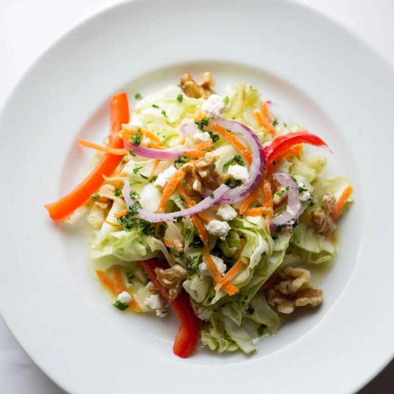 Serving suggestion for Cooked and Loved Cabbage Salad on a rustic wooden table, alongside grilled chicken and a drizzle of tangy apple cider vinegar dressing.