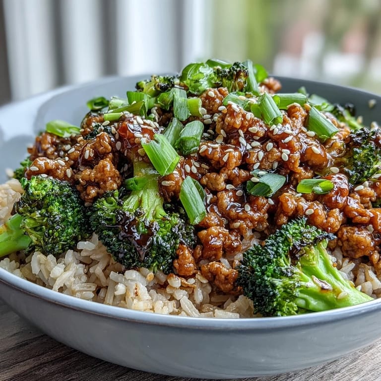 Glossy honey-sriracha glaze coats tender turkey and bright green steamed broccoli in this vibrant Sweet and Spicy Turkey Broccoli Bowls meal prep recipe.