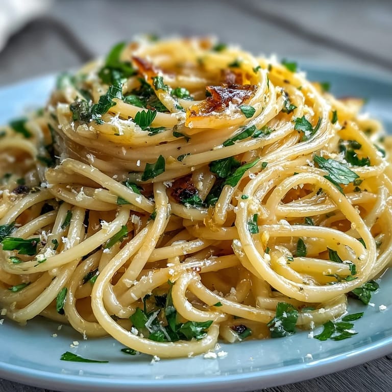 Bright and zesty lemon butter pasta, twirled on a fork with Parmesan and parsley, perfect for a quick vegetarian dinner.