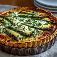Easy Mother's Day Brunch Quiche with Asparagus and Brie, featuring tender green asparagus and creamy melted cheese in a golden crust.