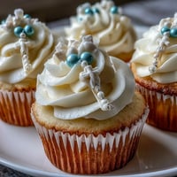 Mini First Communion Cupcakes with Rosary Fondant Toppers: Soft vanilla cupcakes topped with smooth buttercream and delicate fondant rosary toppers for a meaningful celebration.